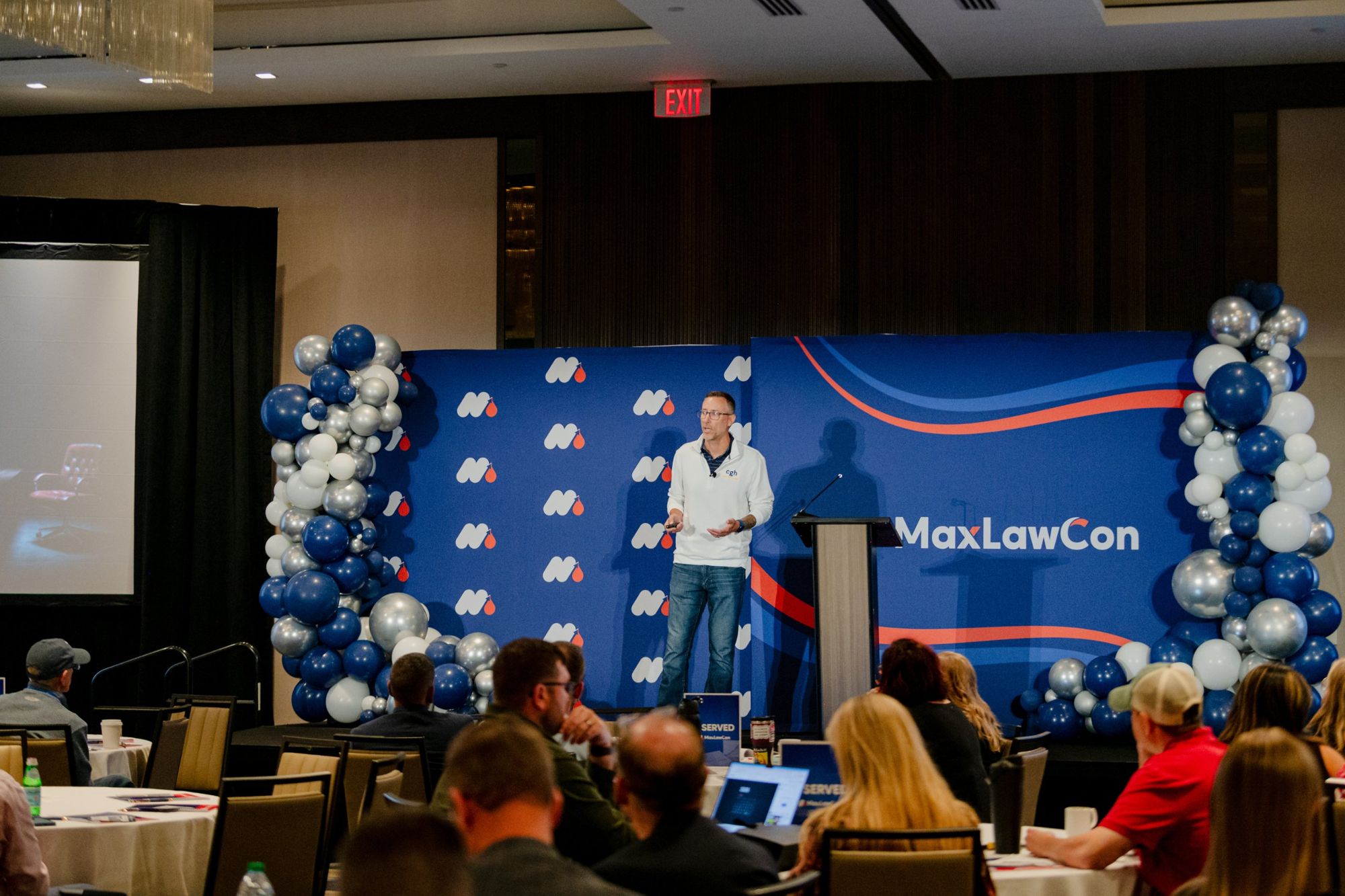 Travis on stage at MaxLawCon with the audience in the foreground